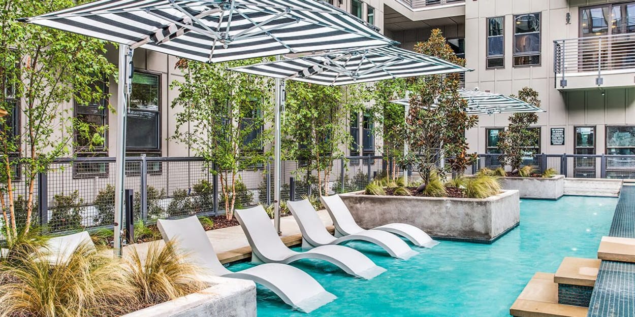 Resort-style in-water lounge chairs at The Cooper, Fort Worth, Texas