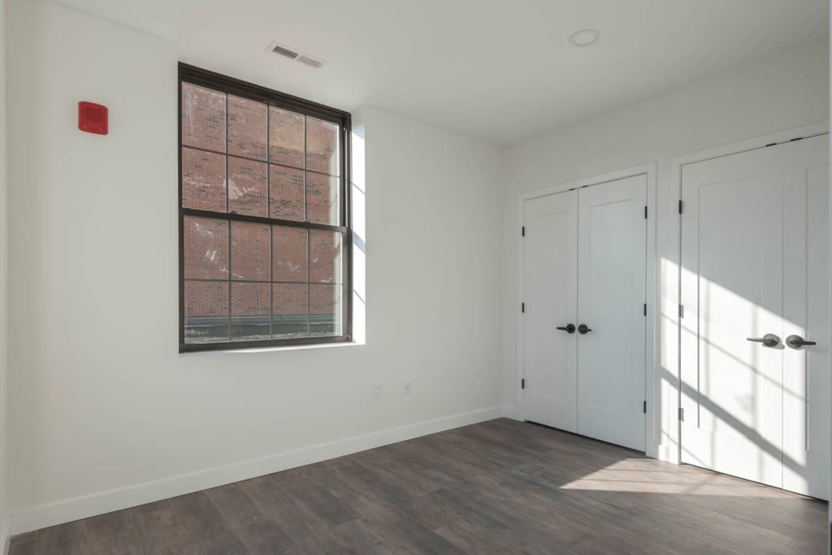 Wood-style flooring in an apartment bedroom at The One Atlantic in Stamford, Connecticut