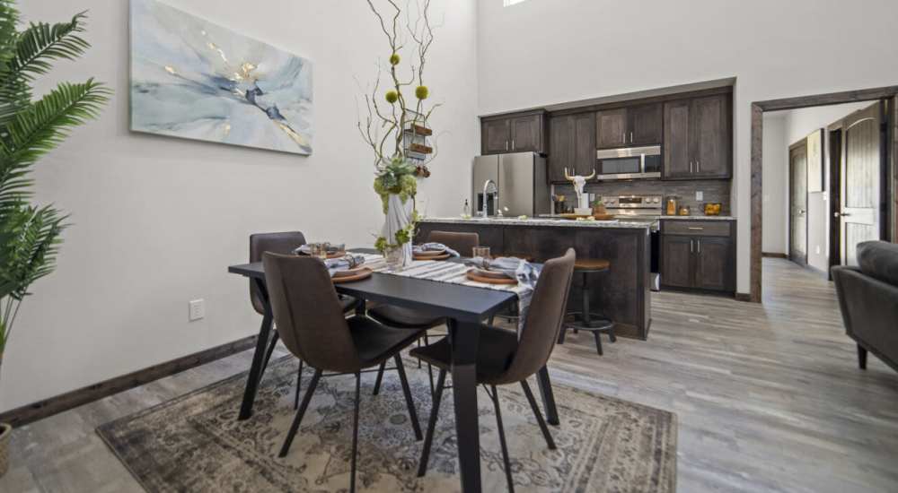 Modern kitchen with dining area at Settlers Trail Apartments in Lindale, Texas