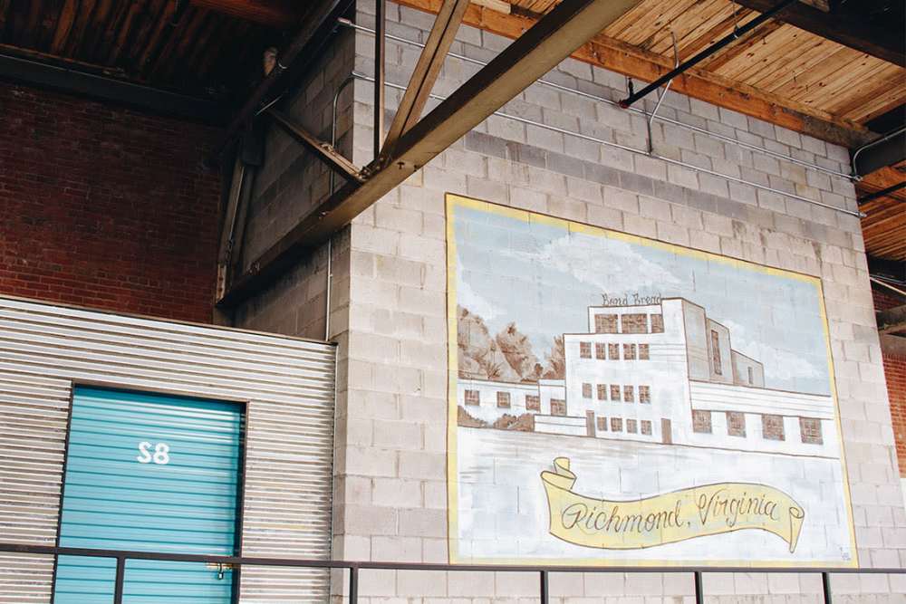 Historic building with mural and blue door at Courtyard Lofts at Scott’s Addition in Richmond, Virginia