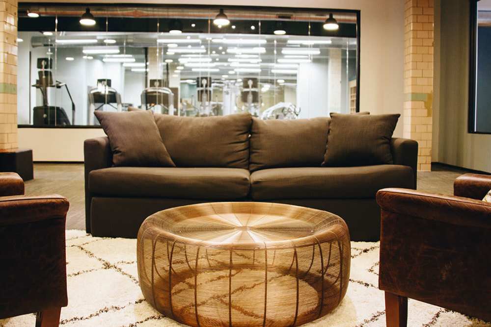 Cozy lounge with modern furniture and gym view at Courtyard Lofts at Scott’s Addition in Richmond, Virginia