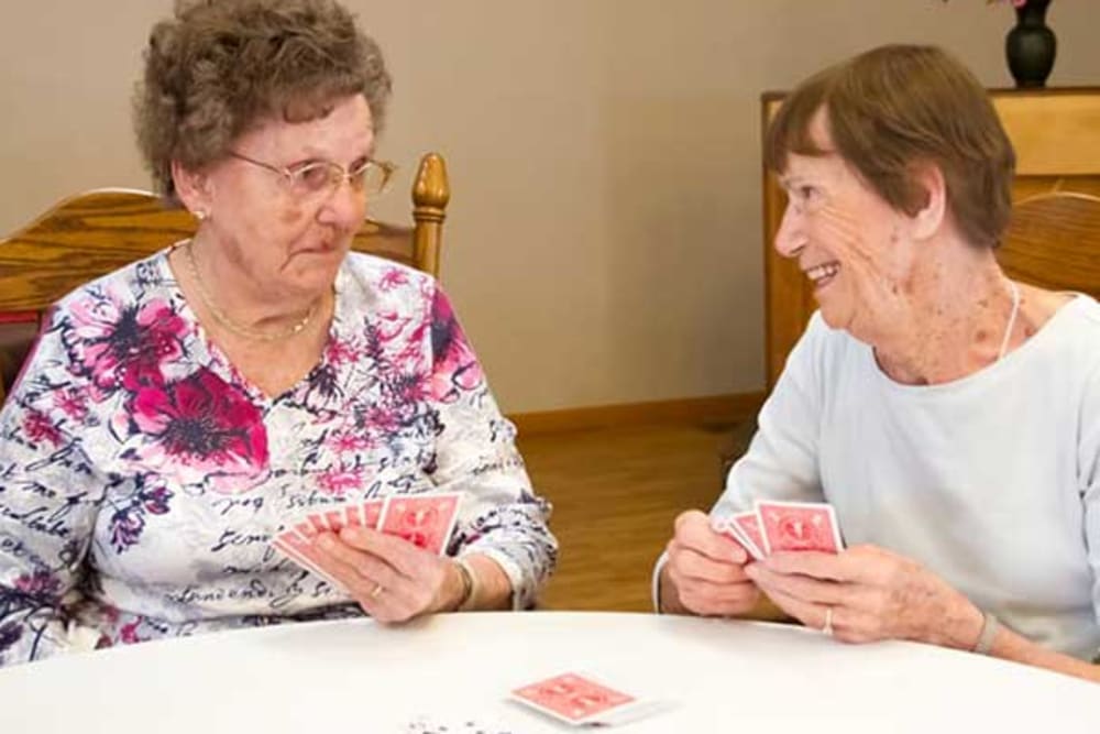 Two residents playing cards at Garden Place Red Bud in Red Bud, Illinois