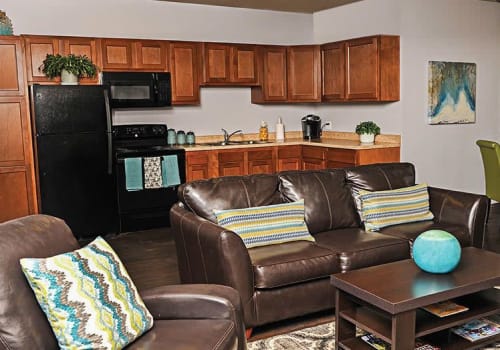 Living room and kitchen view at Webster Manor Apartments home in Webster, New York