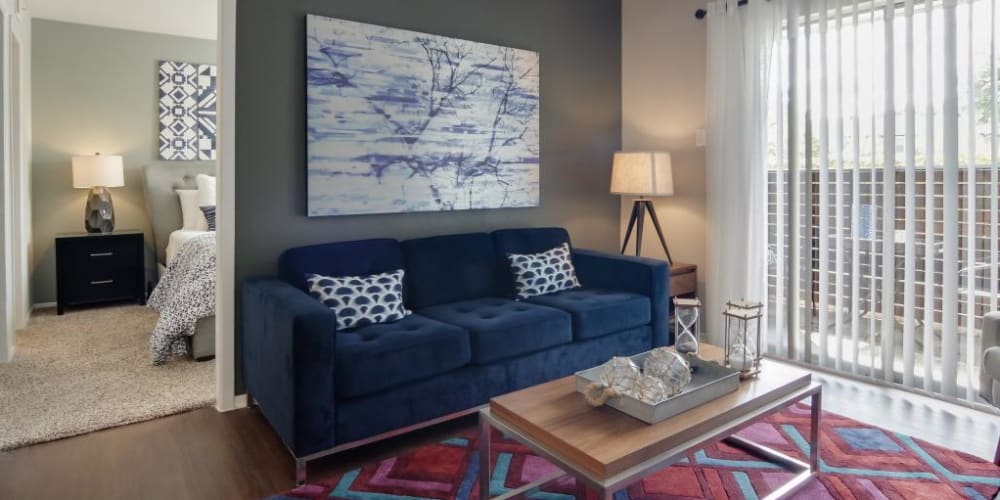 Living room area with full sliding glass door to the patio at The Landings at Steeplechase in Houston, Texas