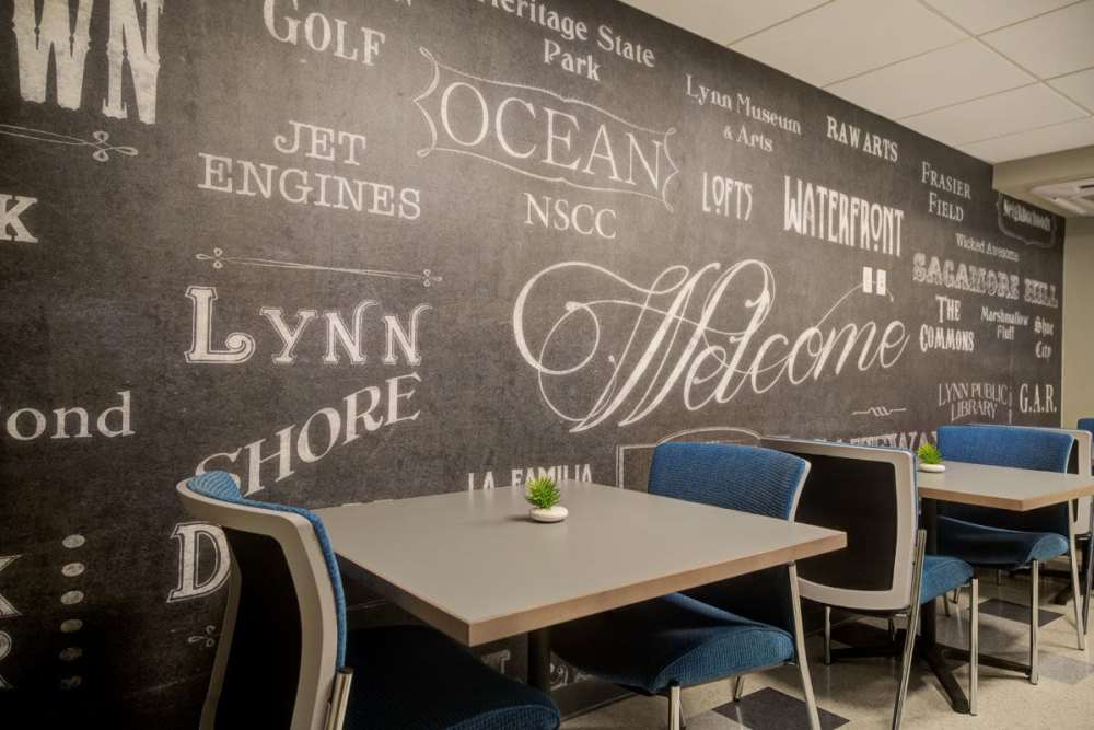 Community seating area with chair and tables at Gateway North in Lynn, Massachusetts