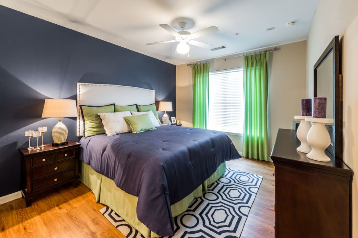 Bedroom with wood style flooring at Marquis at Canyon Ridge in Austin, Texas