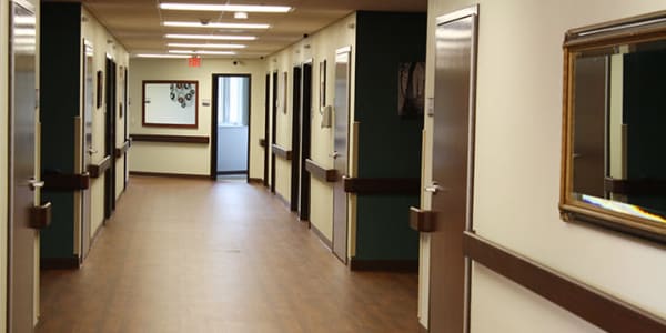 Facility hallway with resident suites at East Troy Manor in East Troy, Wisconsin