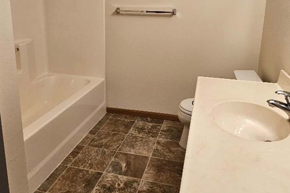 Bright bathroom with sink, commode and bathtub at Westwood Parkway Estates in Saint Cloud, Minnesota