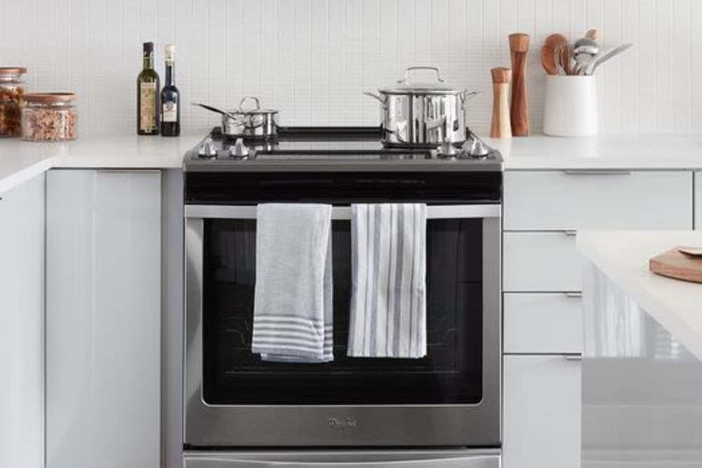 Fully-equipped kitchen with stainless steel appliances and storage units at Ardan in Dallas, Texas
