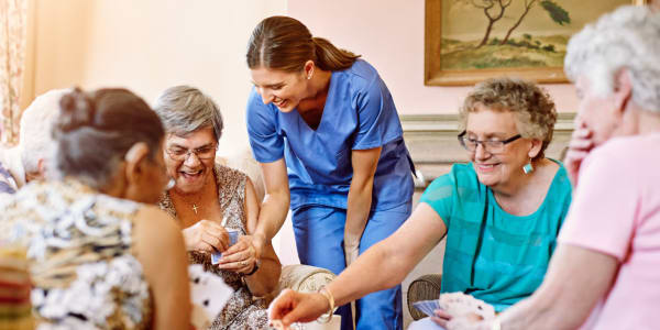 Resident caretaker enjoying time with a group of residents at Geneva Lake Manor in Lake Geneva, Wisconsin