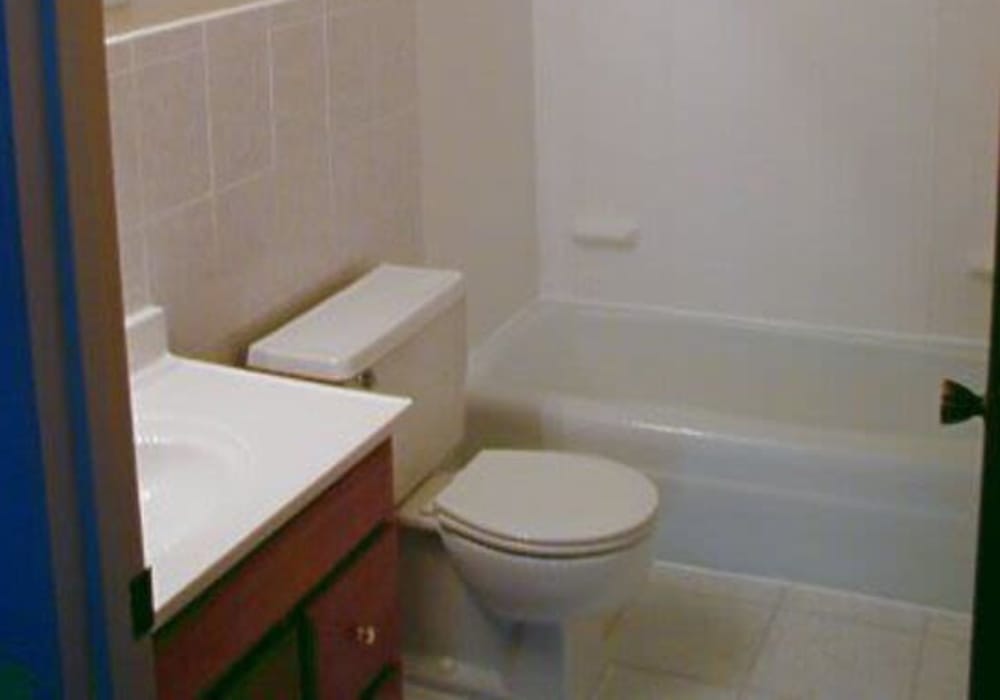 Clean, modern bathroom with tub and shower at Jefferson Manor Townhomes in Fairport, New York