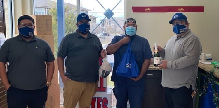Employees holding food at Storage Star Denver in Denver, Colorado