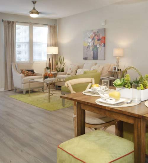 Stylish dining area with modern decor and cozy living space at Messina Luxury Apartments in New Smyrna Beach, Florida