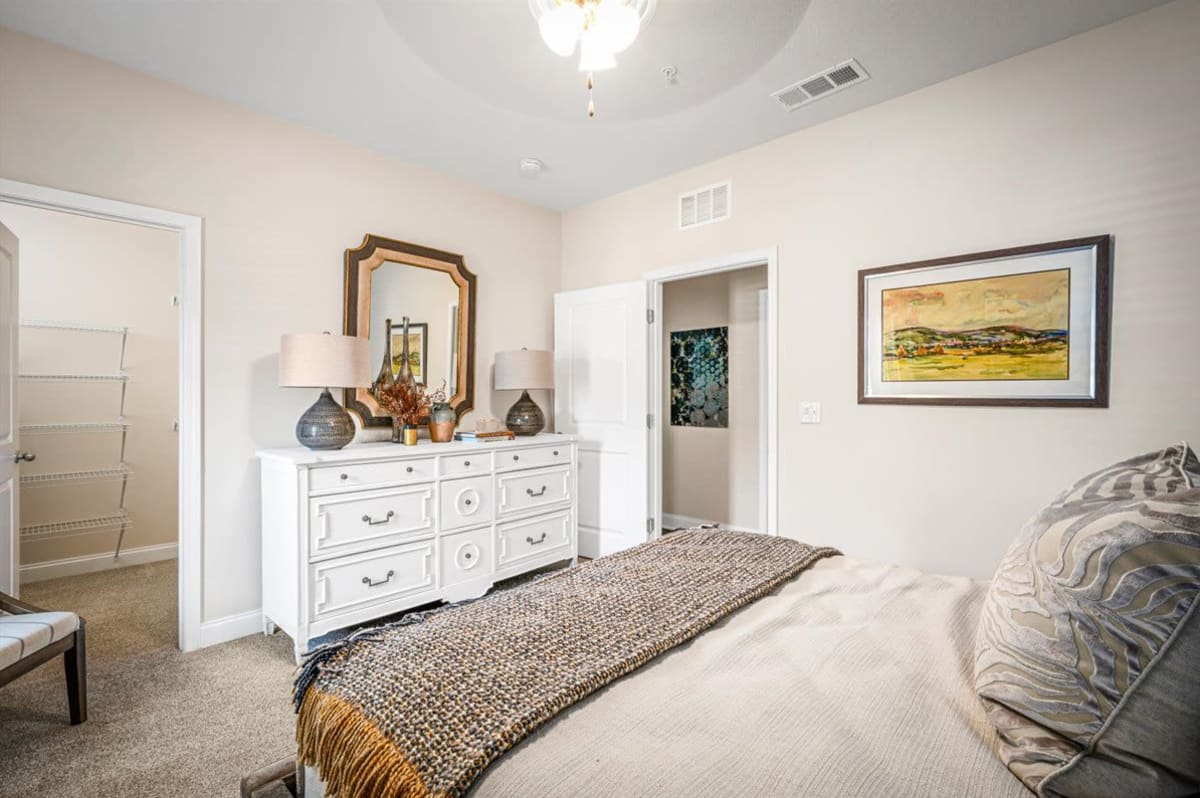 An apartment bedroom with the door open at Bowman Station in Macon, Georgia