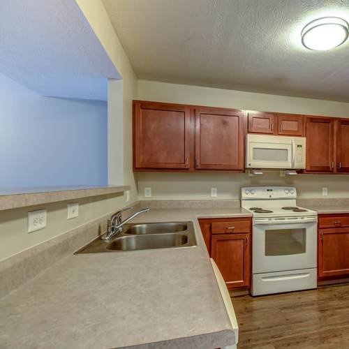Townhome kitchen with granite countertops and appliances at Hyden Greene in Philippi, West Virginia