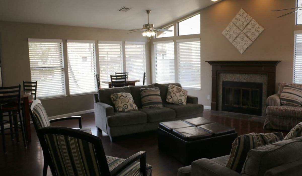 Clubhouse with fireplace and large windows at Oak Park in Turlock, California