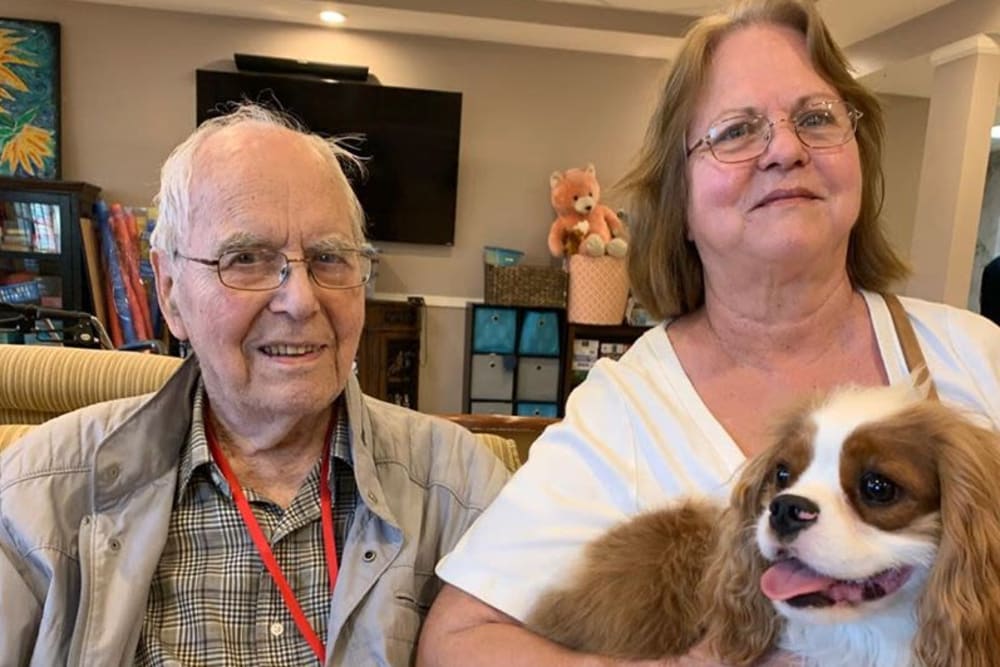 Resident taking a photo with his daughter and dog at Inspired Living Sarasota in Sarasota, Florida