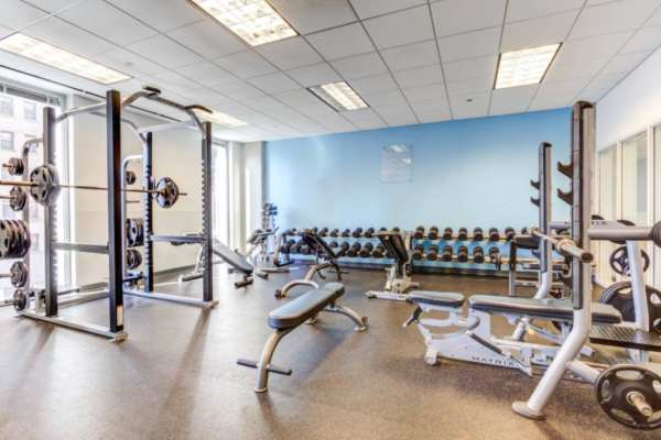 Weightlifting equipment and benches in gym at The Flats at East West University in Chicago, Illinois