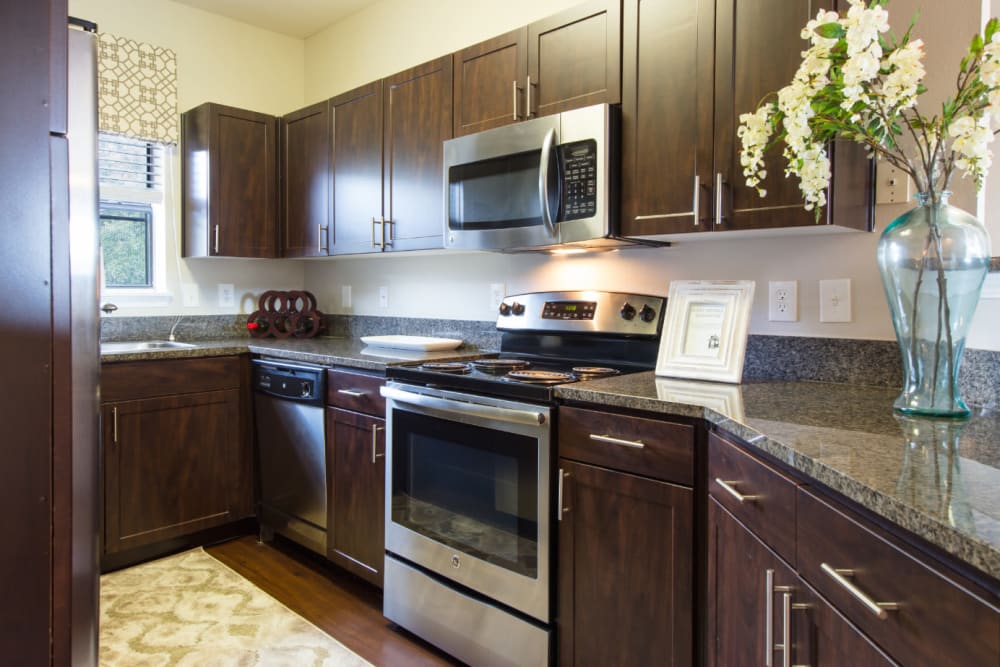 Kitchen with granite counters at Marquis at Treetops in Austin, Texas