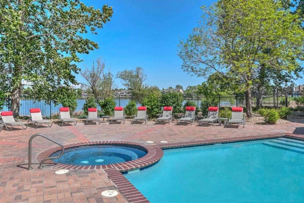 Serene swimming pool with hot tub at Promenade at Hunter's Glen Apartments in Thornton, Colorado