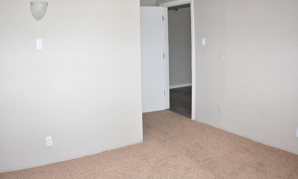 Unfurnished bedroom connecting to living space at Truckee River Terrace in Reno, Nevada