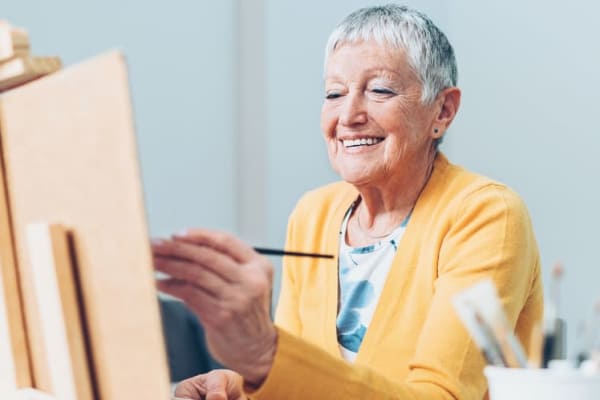 Senior woman painting at BPM Senior Living