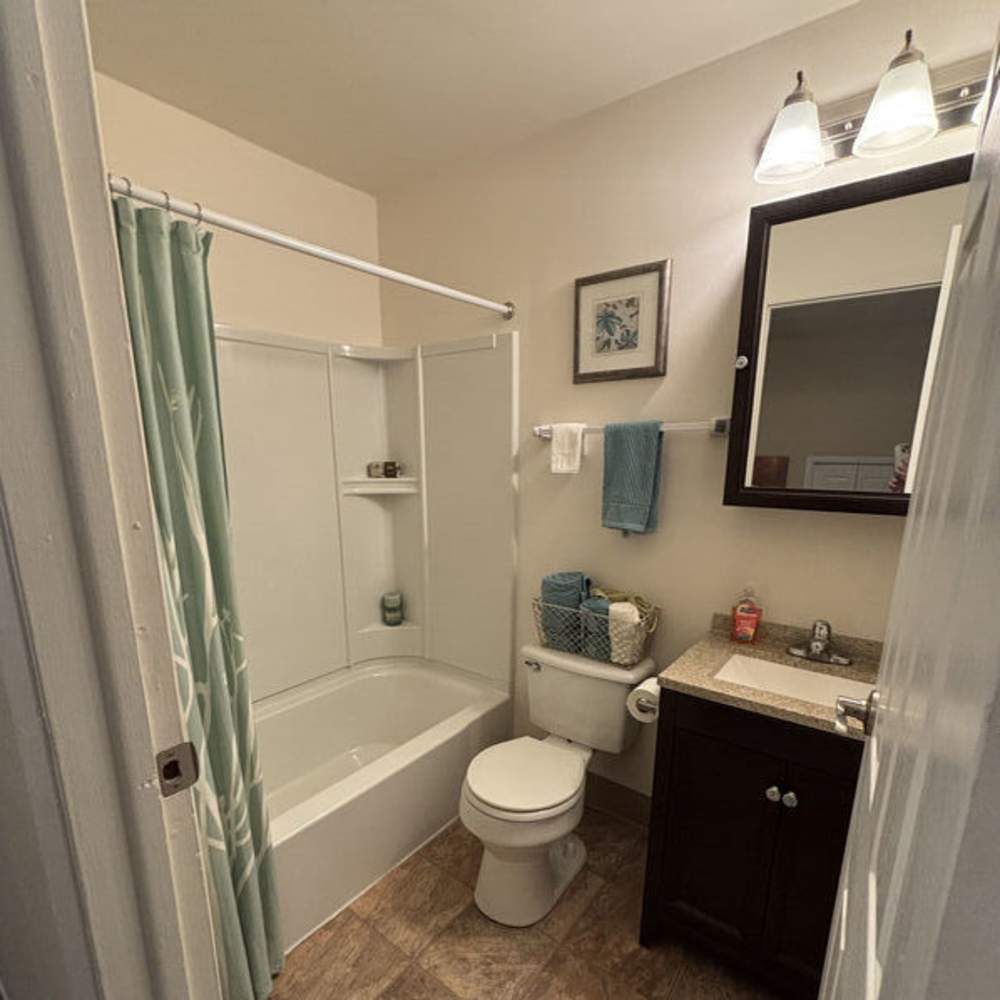 Cozy bathroom with modern fixtures and elegant touches at Woodland Estates in East Rochester, New York