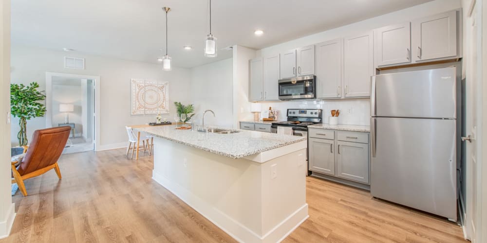 Large kitchen with white cabinets appliances and washer dryer at The Mason in Ladson, South Carolina