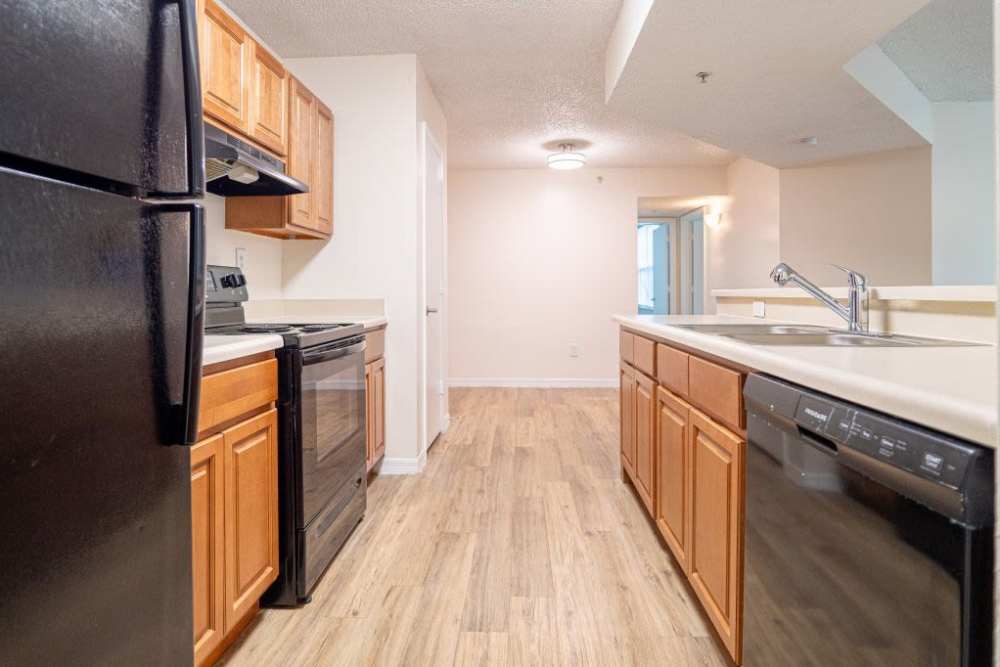 Kitchen with access to living room and wooden cabinets at Logan Heights in Sanford, Florida