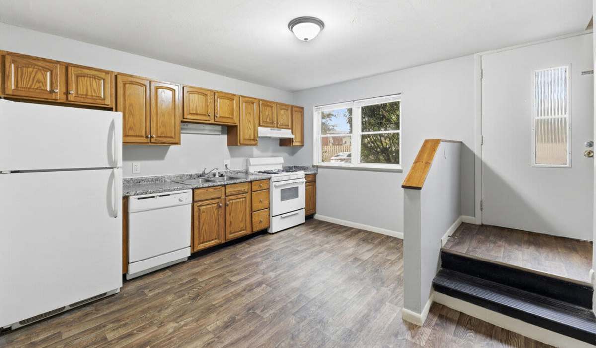 Charming modern kitchen with warm wooden cabinetry and ample natural light at The Reserve at Pin Oak Manor Apartments in Mishawaka, Indiana.