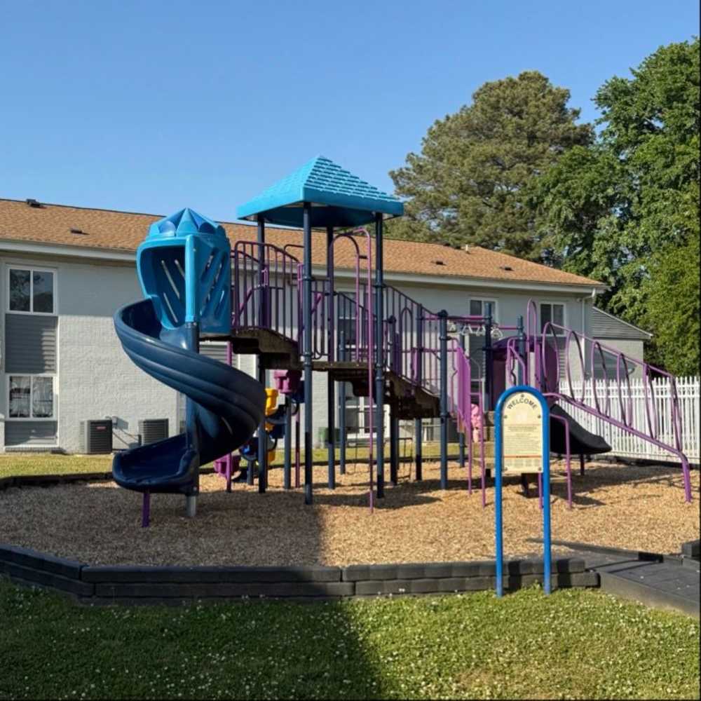 Playground with slide and climbing structures at Pebblestone Gardens in Newport News, Virginia