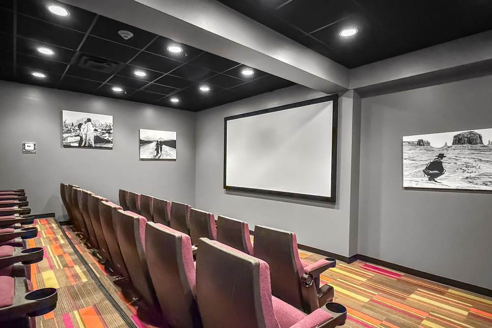 Classic movie theater with rows of recliner seating and dual screens at The Franklin in Ankeny, Iowa