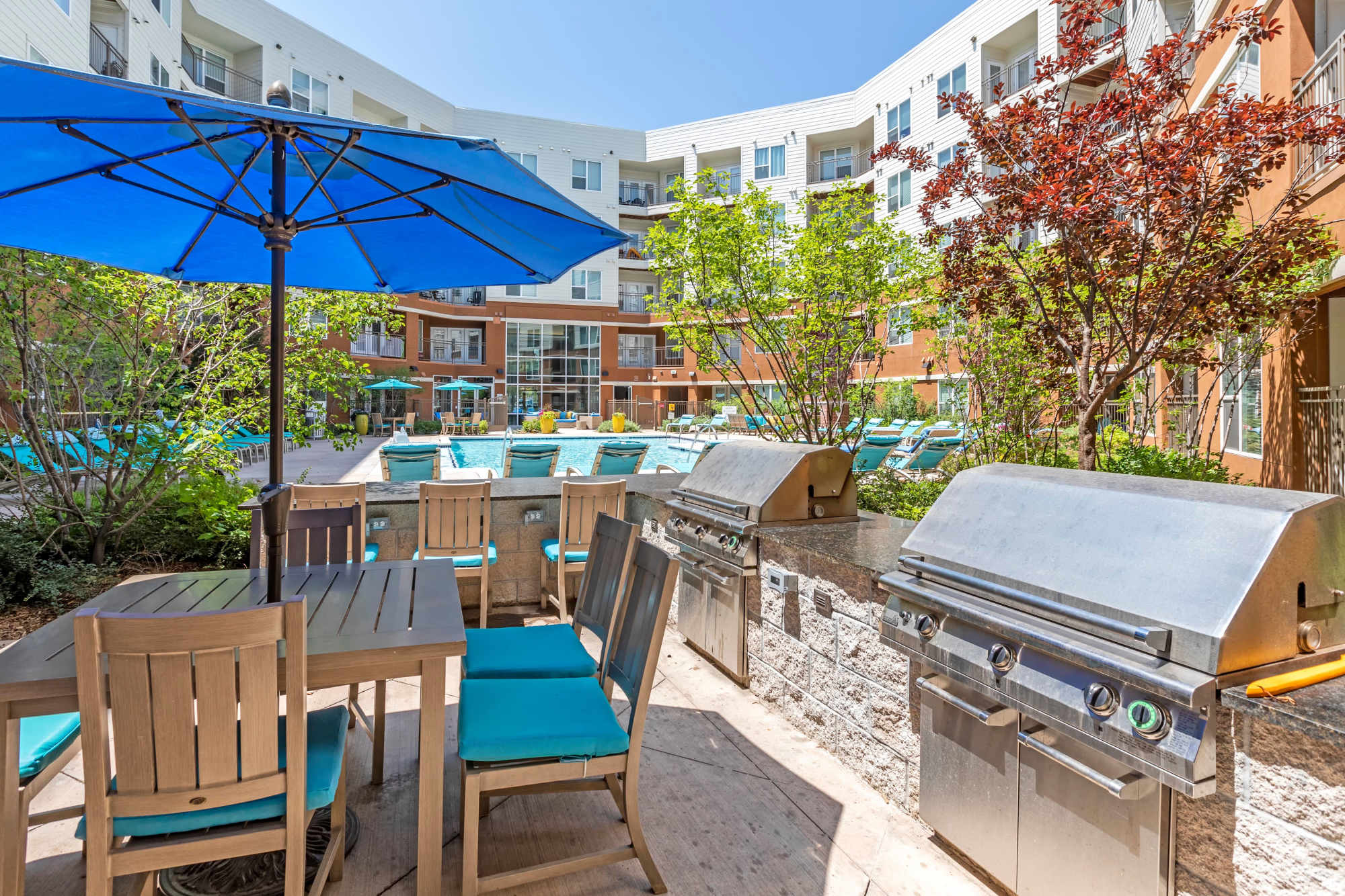 Outdoor lounge near poolside and BBQ grilling area at Helios in Englewood, Colorado