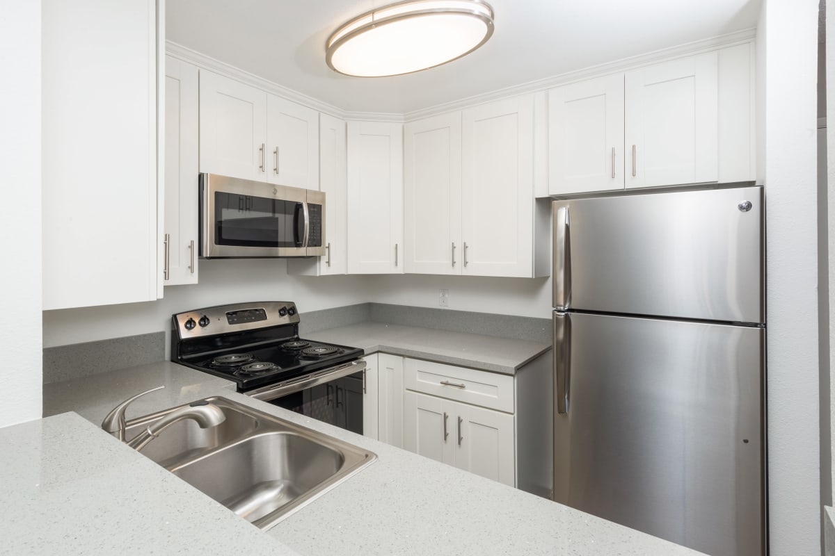 Kitchen with all electric appliances at Los Feliz Village in Los Angeles, California