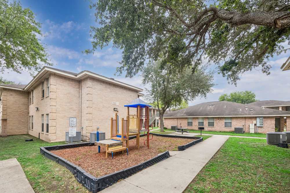 Playground area at apartment community at Cameron Village Apartments in Alice, Texas