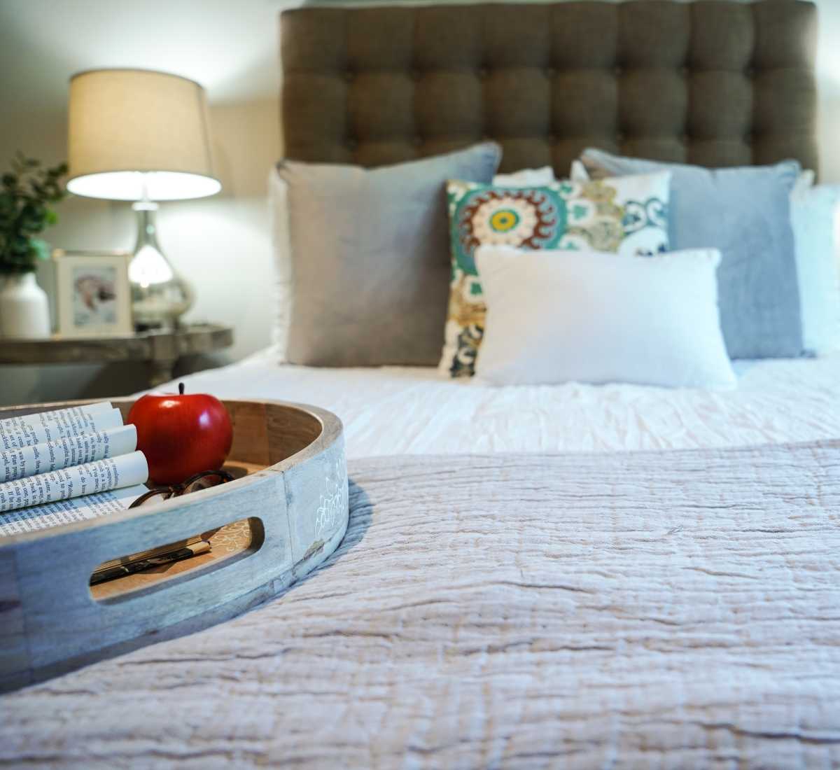 Bedroom with a tray containing fruits at Harmony on the Peninsula in Yorktown, Virginia