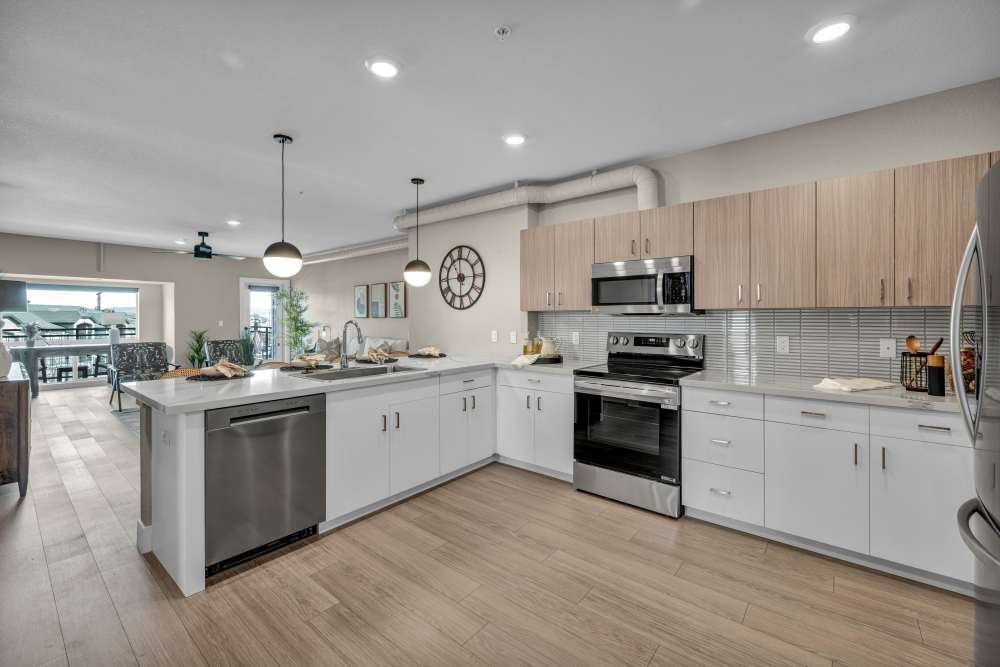Modern kitchen with island and stainless steel appliances at Stone Village Apartments in Reno, Nevada