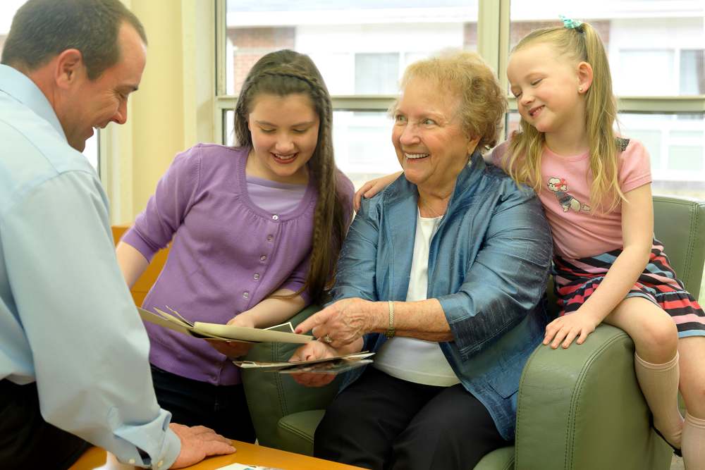 Resident looking at photos with family at O'Fallon in O'Fallon, Missouri
