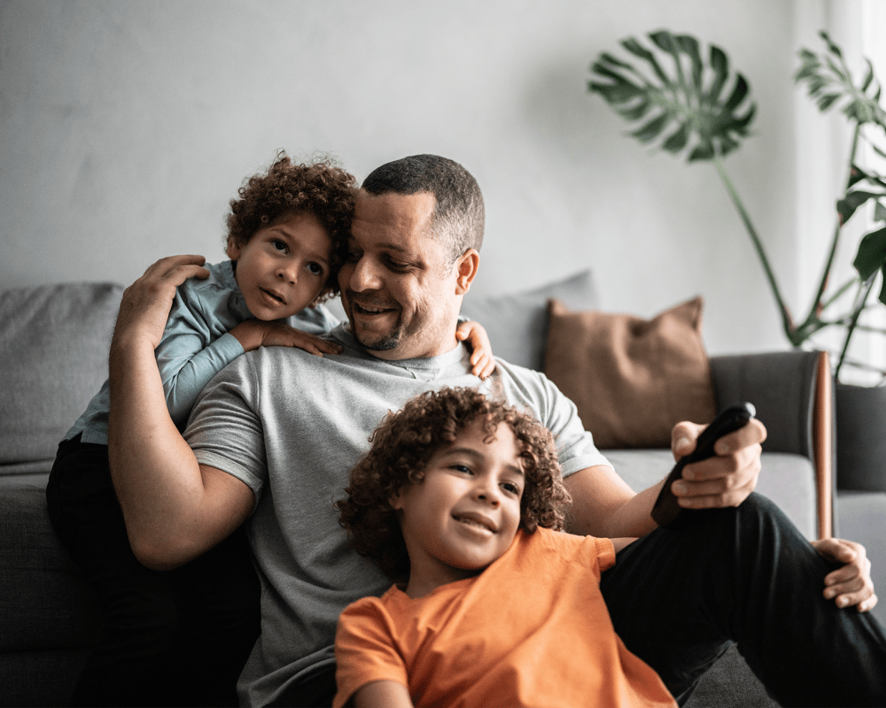 Father with his sons having fun in their living room at Shaff Square Apartments in Stayton, Oregon