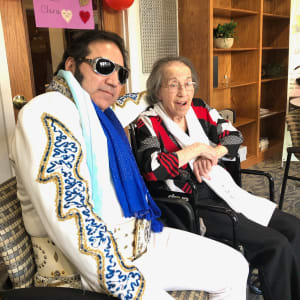Resident Clara with Elvis Presley impersonator at The Atrium in Rockford, Illinois.