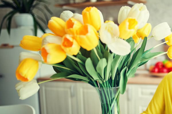 Coffee cup with vase of tulips and a book at  a Radiant Senior Living community