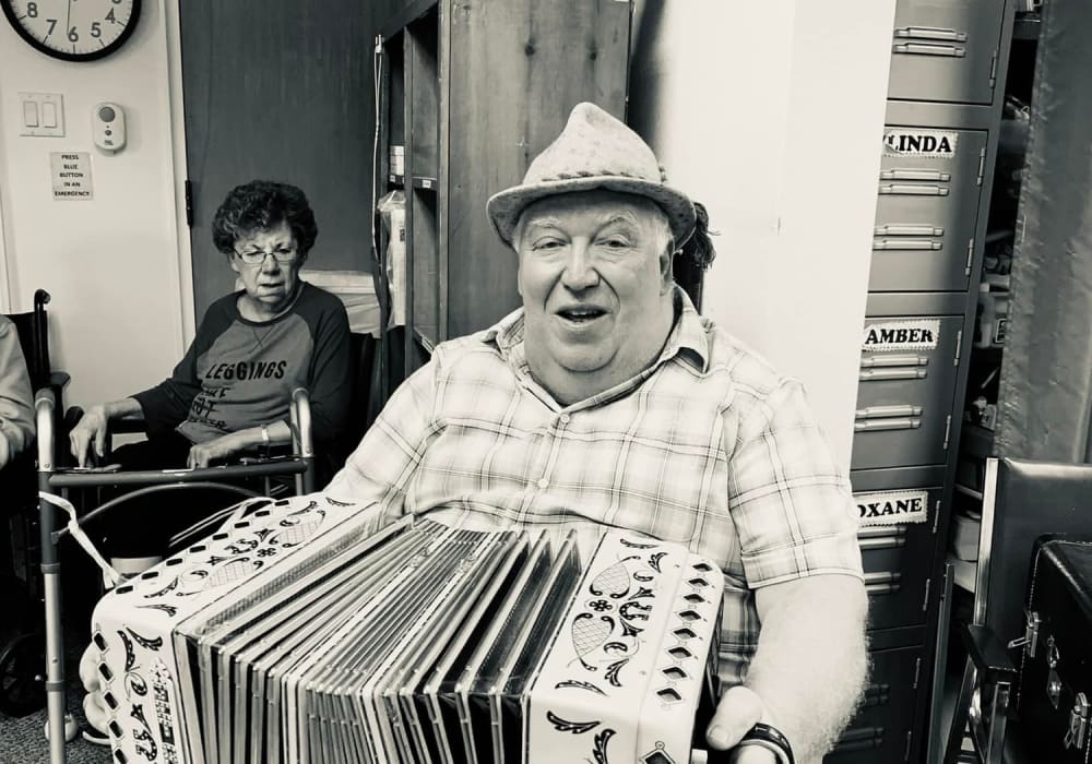 Resident with accordian at Bell Tower Residence Assisted Living in Merrill, Wisconsin