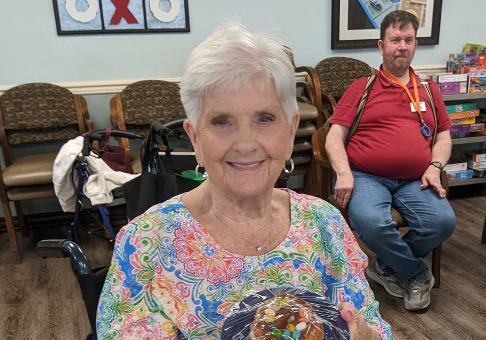 Resident showcasing her meal at Truewood by Merrill, Clovis in Clovis, California