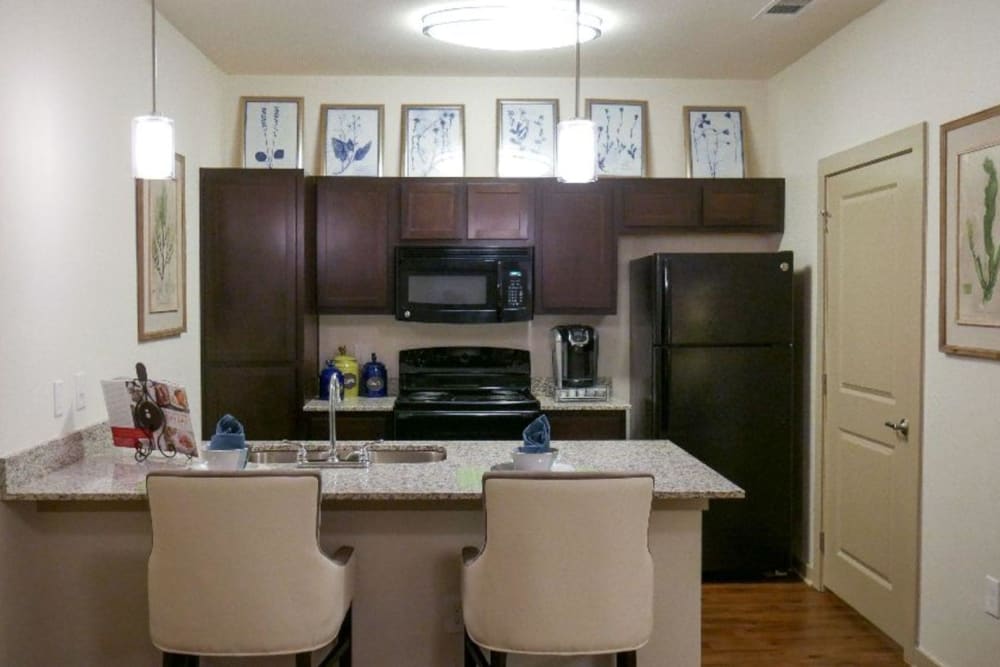 Model kitchen with island bar seating at Anatole on MacArthur in Oklahoma City, Oklahoma