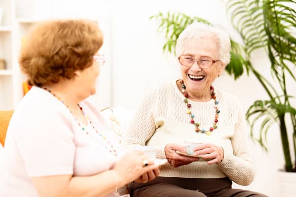 Two residents spending time with each other and laughing at White Springs Senior Living in Warrenton, Virginia
