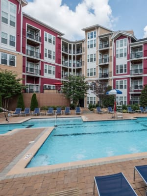 Resident sitting on the side of the pool soaking their legs at Echelon at Odenton in Odenton, Maryland