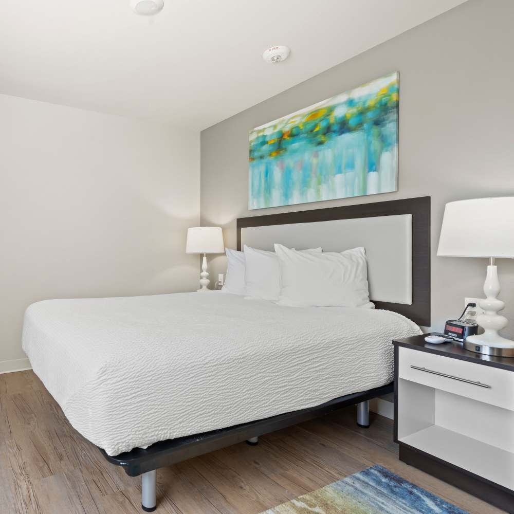 Bedroom with night stand at WaterWalk Kansas City - Overland Park in Overland Park, Kansas