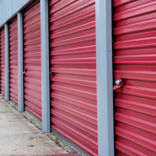 Close-up on red storage unit doors with a padlock at Red Dot Storage in Denham Springs, Louisiana
