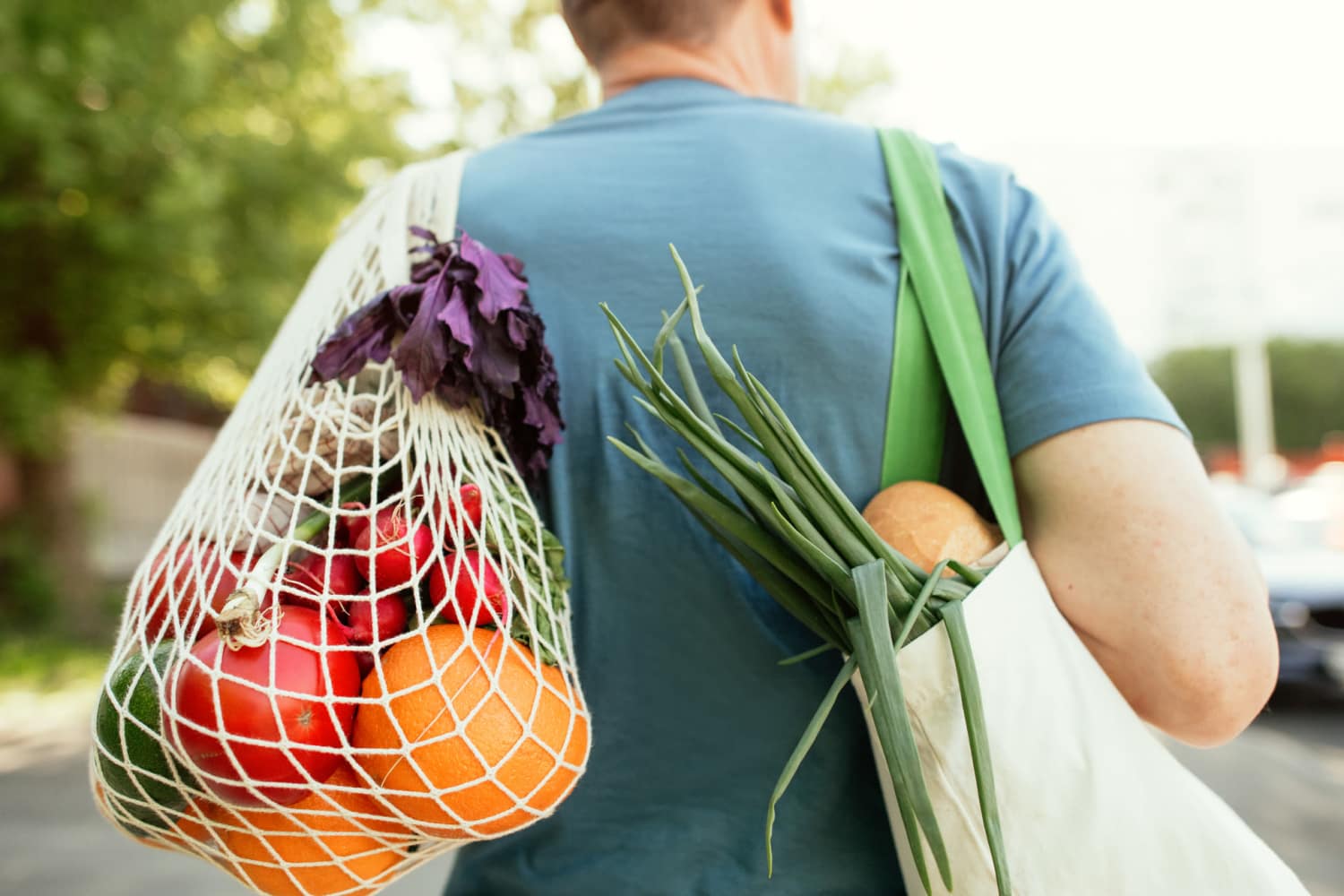 Person carrying fresh vegetables and fruits at Pomona Apartments in Ocala, Florida