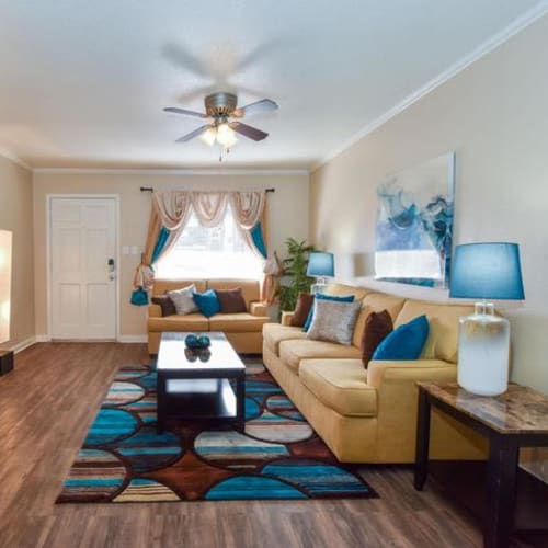Decorated living room interior at Falls Of Maplewood in Houston, Texas